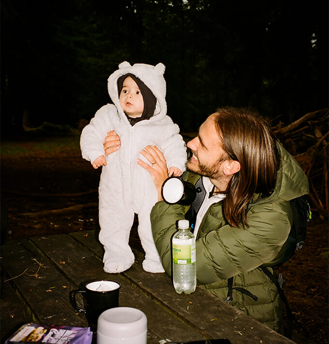 Man holding a child on the evening